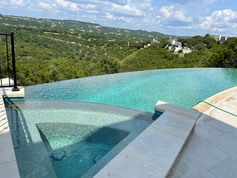 infinity pool with spa overlooking the hillside