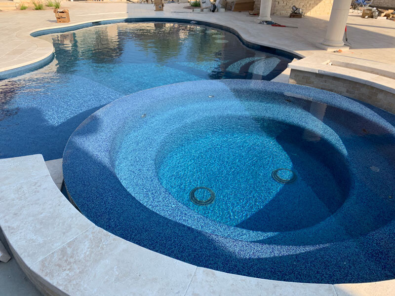 multi-level spa next to custom curved pool