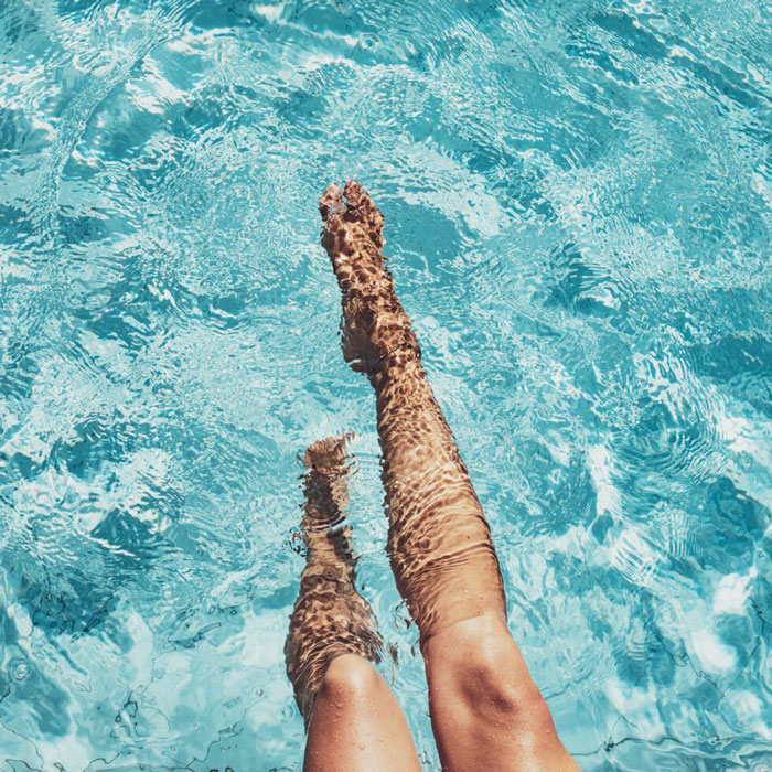 legs wading in pool water