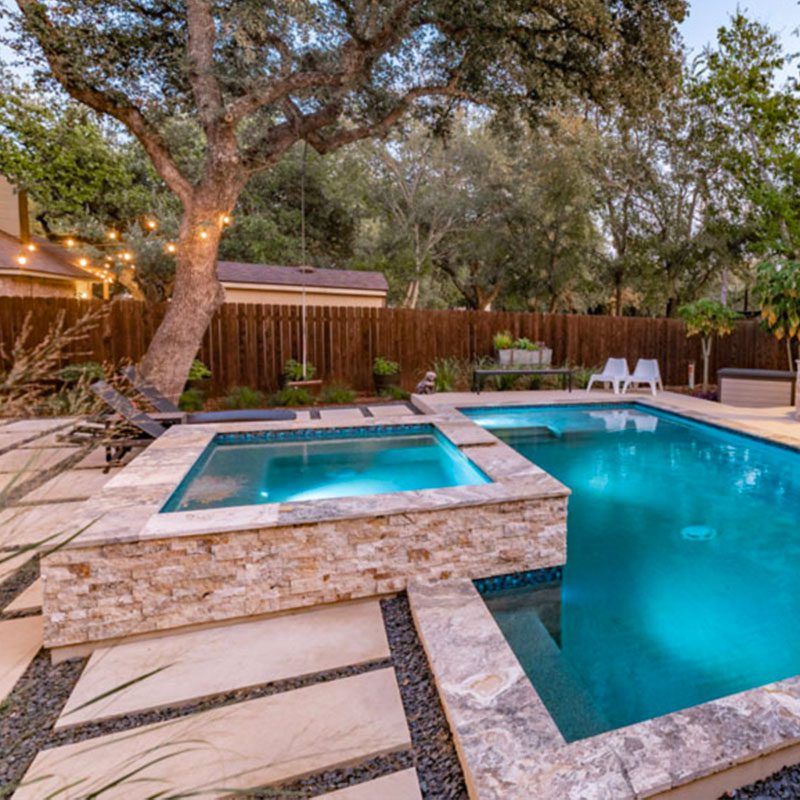 custom stone edge backyard pool with spa