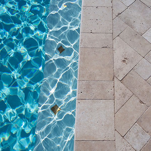 custom stone tiling along pool edge