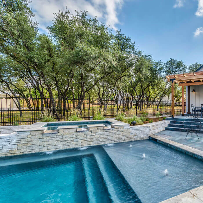 pool with upper level hot tub and wading area