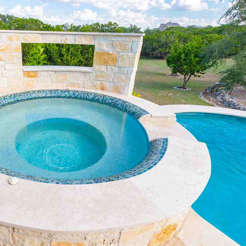 spa with custom tiles and privacy wall overlooking main pool