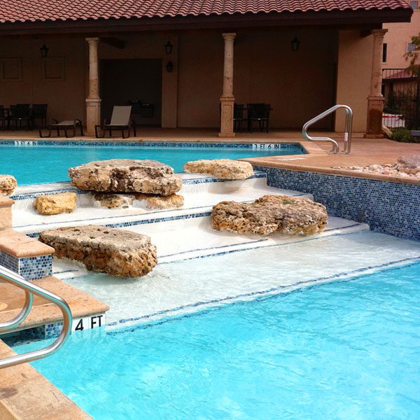 custom stepping stones on stairs of a commercial pool